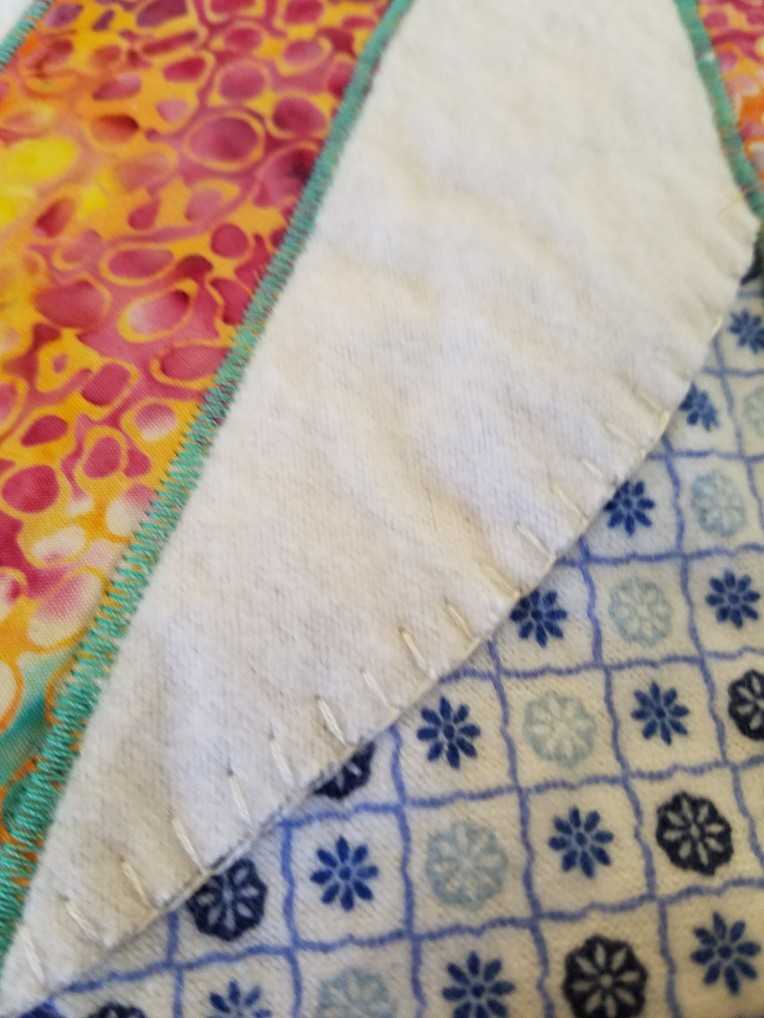close up of satin stitch and buttonhole stitch